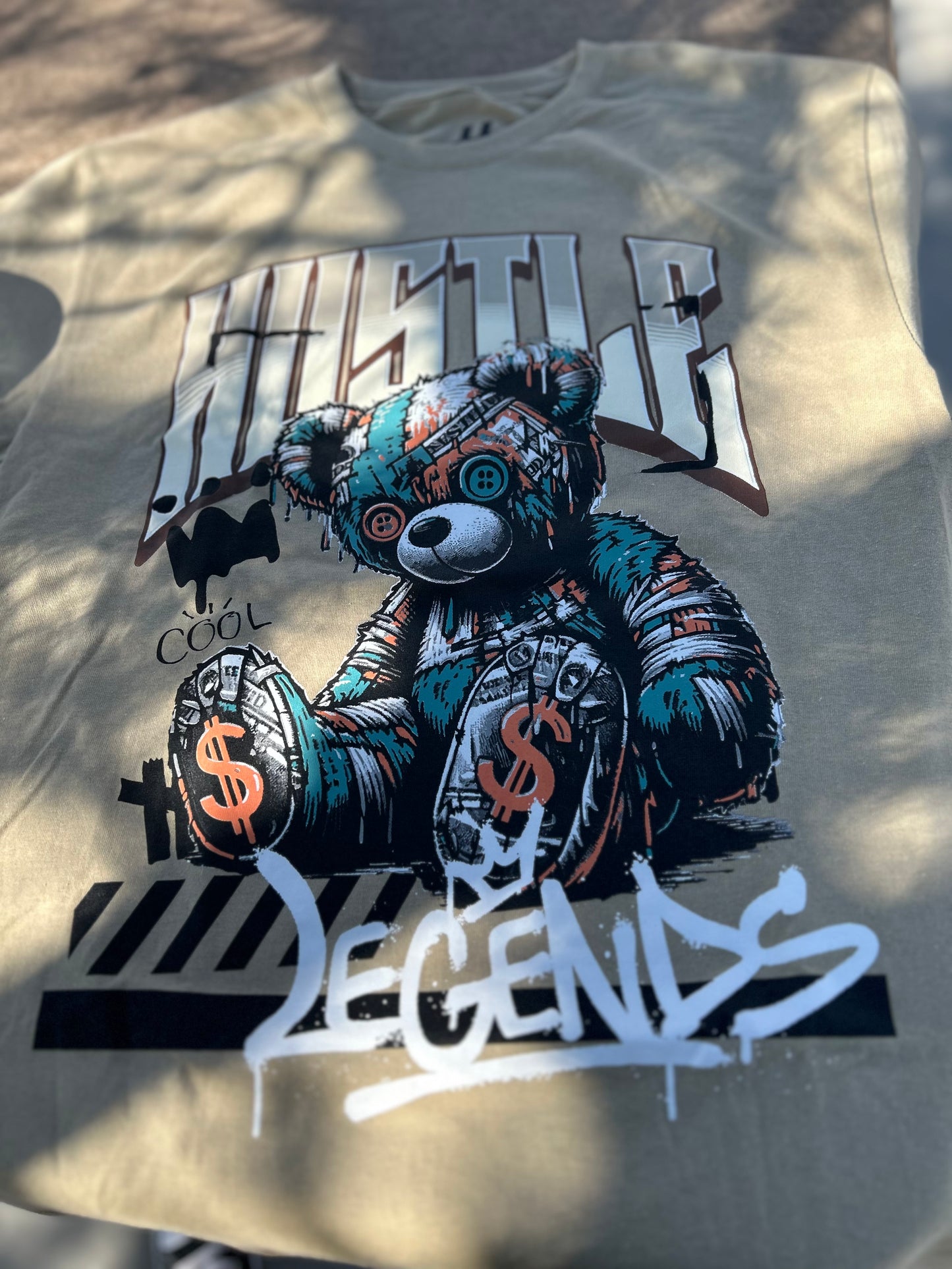 T-shirt with a graphic of a teddy bear and text on a light background